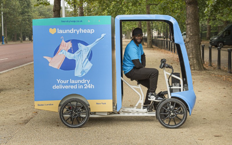 Laundryheap delivery driver on an e-bike