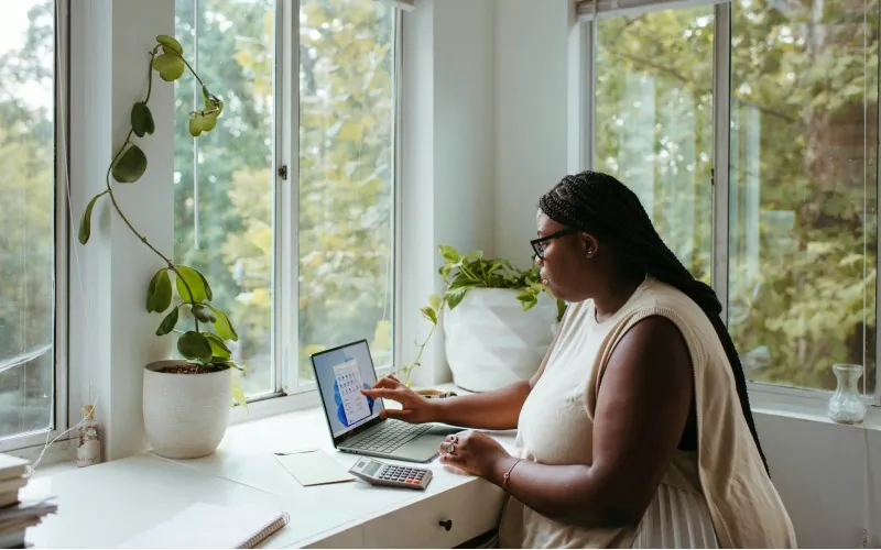 Woman on computer. Credit: Windows, Unsplash