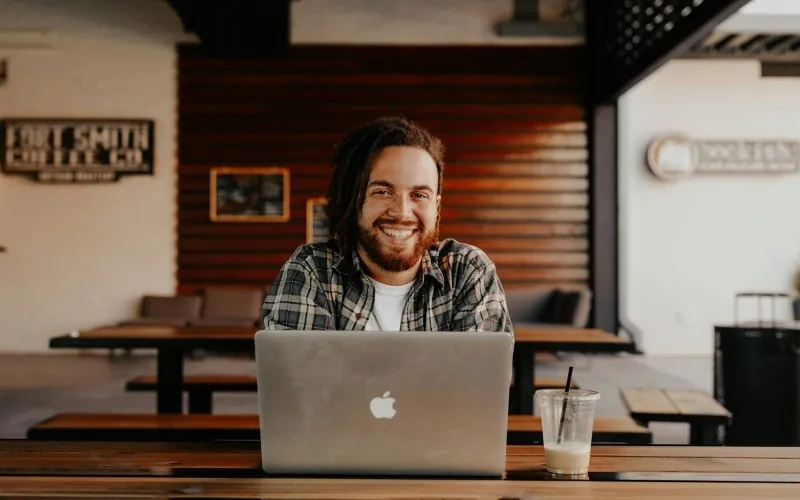 Man with Apple MacBook laptop