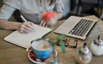 Manking notes next to laptop