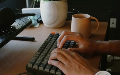 Person typing on keyboard