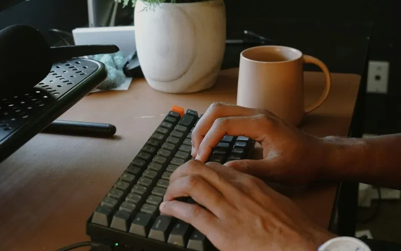 Person typing on keyboard