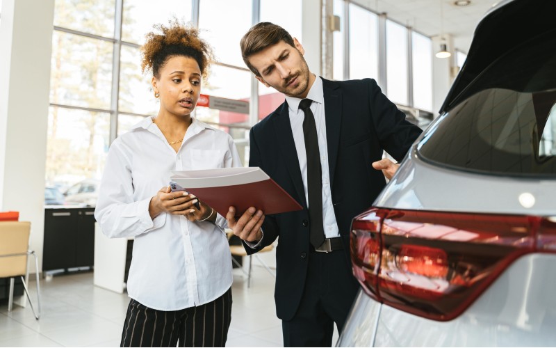 Car dealer and buyer discussing buying a used car