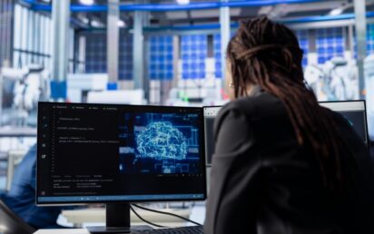 Engineer developing AI algorithms on PC in solar panel plant